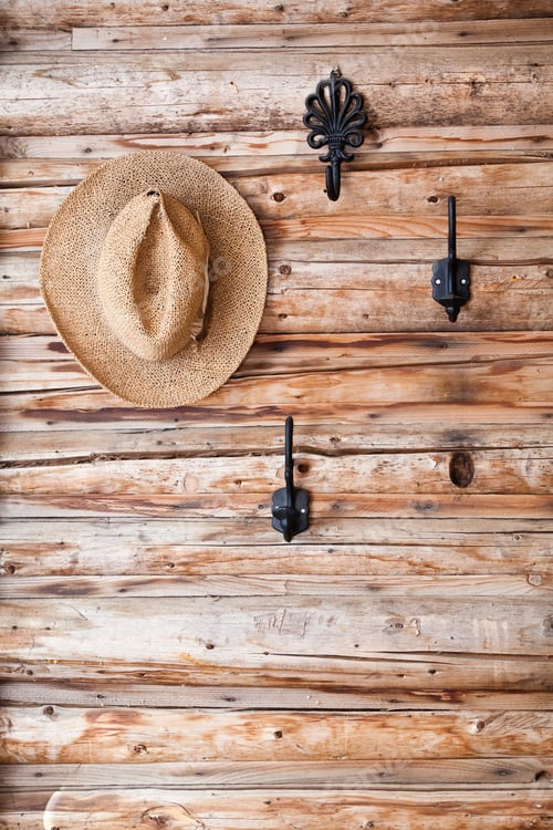 Preview: Straw Hat Hanging on Rustic Wood Wall