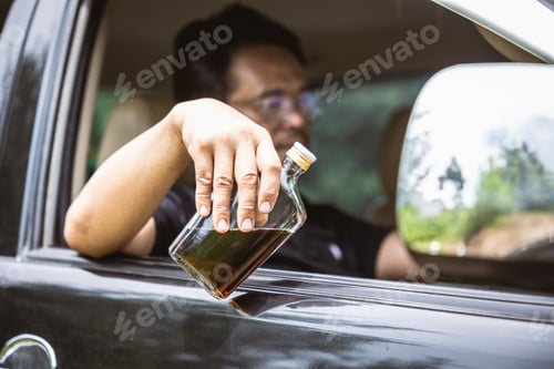 Preview: man drunk during drive a car. driver with alcohol whisky bottle dangerous and illegal concept.