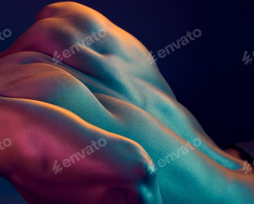 Preview: Shot of a muscular man posing against a studio background