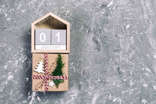 Preview: Christmas calendar 1 january. Christmas gift, fir branches on vintage, toned wooden white