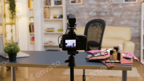 Preview: Zoom in shot of empty influencer room with cosmetics on the table and professional recording