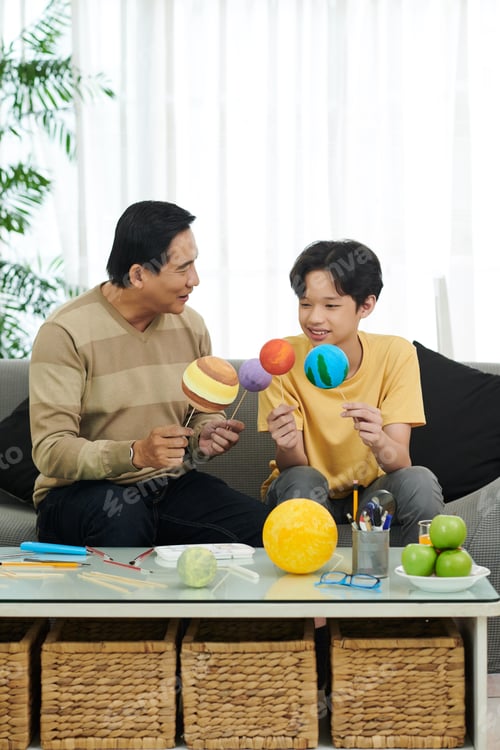 Preview: Father and Son Finishing Solar System Model