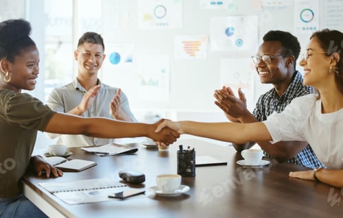 Preview: Two businesswoman shaking hands in a meeting at work. Business professionals greeting and making de