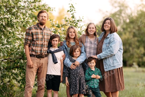 Preview: Family portrait of a large family in the summer in the field