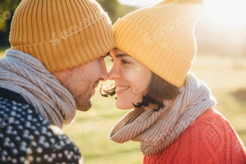 Preview: Outdoor portrait of lovely female and her boyfriend, look at each other`s eyes