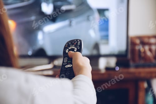 Preview: Young girl holding a remote to flip channels on a TV