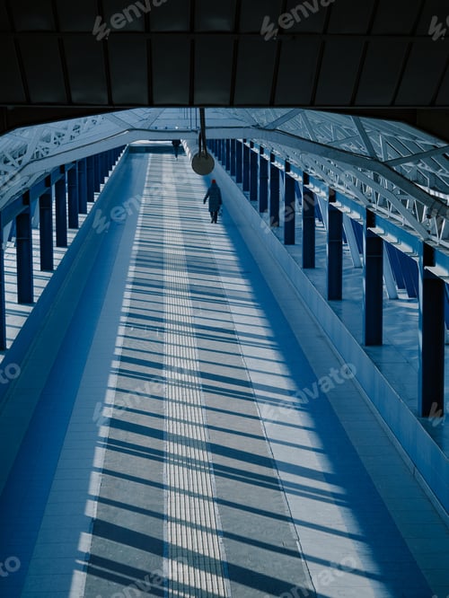 Preview: Modern pedestrian bridge on a sunny day with light shadows