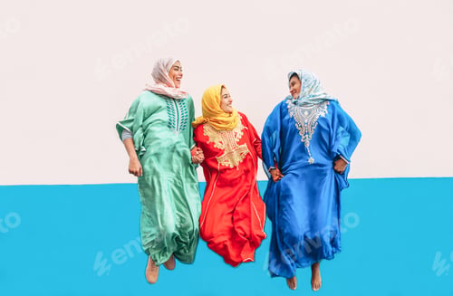 Preview: Happy Muslim girls jumping together outdoor - Arabian women having fun in the college