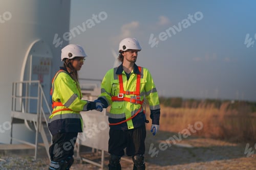 Preview: Sustainable energy industry - Engineers working at alternative renewable wind energy farm