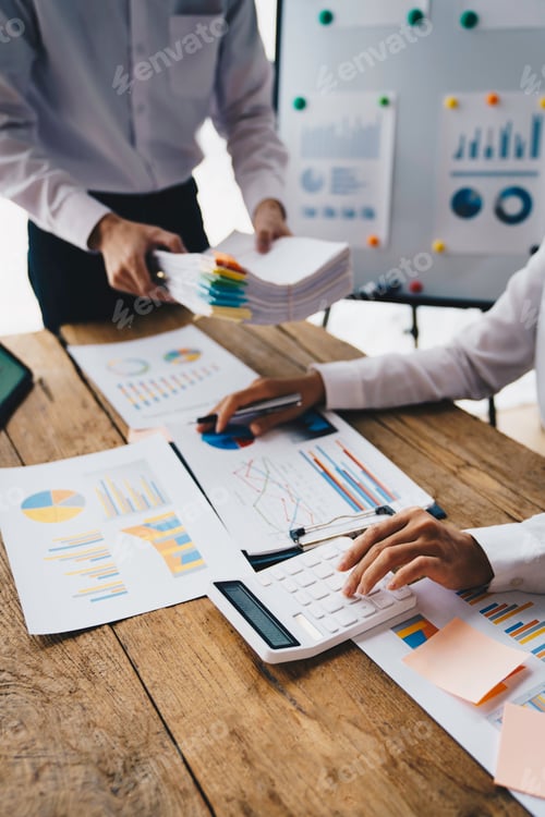 Preview: Business team finance or bookkeeper working with a calculator to calculate business data summary rep