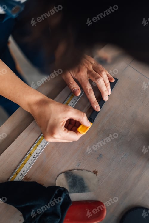 Preview: Close up of creative female potter's hands measuring clay details.