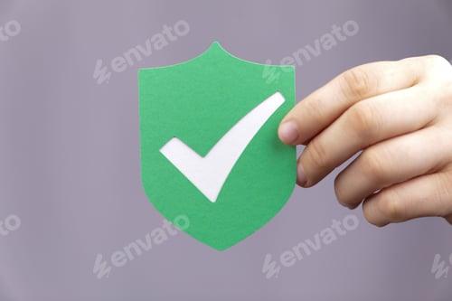 Preview: Close-up shot of a hand holding a shield privacy secure protection icon on a blurred background