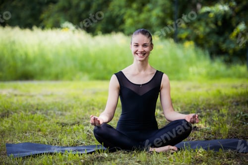 Preview: yoga woman on green grass in lotus pose smiling