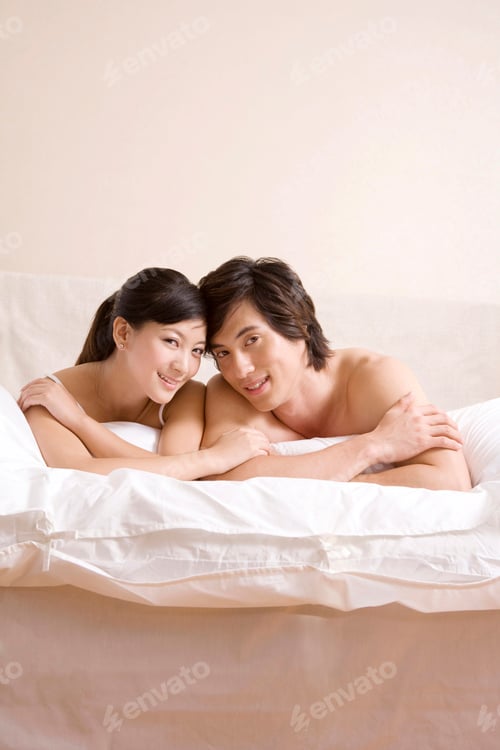 Preview: Asian couple close to each other on bed