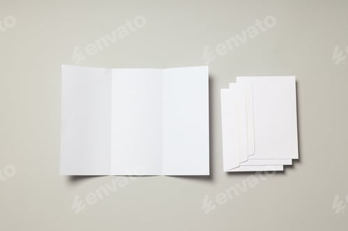 Preview: Blank white sheet and envelopes on light gray background