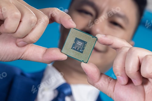 Preview: Businessman Holding Microchip Close-Up