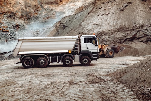 Preview: Industrial dumper trucks working on highway construction site, loading and unloading