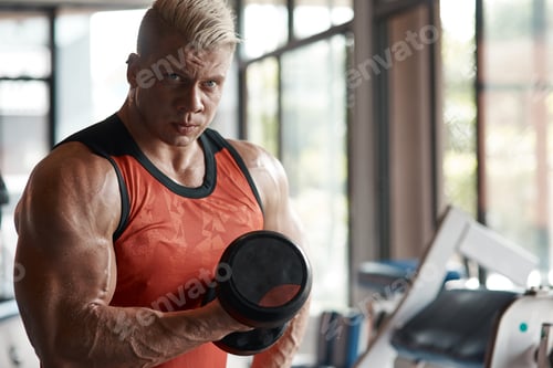 Preview: Serious body builder lifting a dumbbell