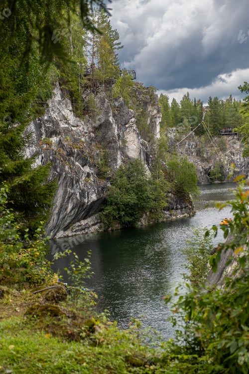 Preview: Marvel at the tranquil waters of Marble Canyon in Ruskeala Mountain Park, framed by towering cliffs