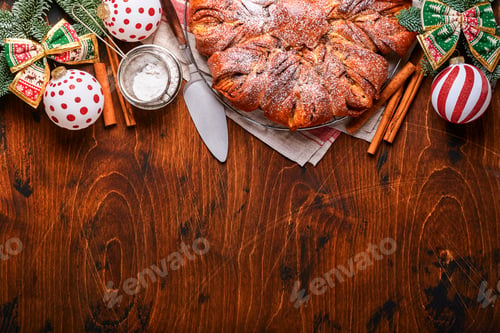 Preview: Christmas star braided chocolate and cinnamon bread on old brawn wooden table. Copy space for text.
