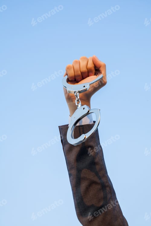 Preview: Business man showing handcuffs after releasing it.