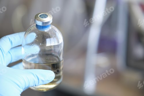 Preview: Researcher hand wearing gloves holding a bottle for anaerobic cultures, with cap and septum