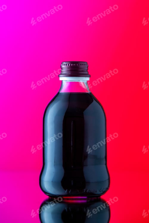 Preview: front view glass bottle with black juice on pink red background