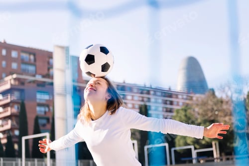 Preview: smiling caucasian woman head touching soccer ball
