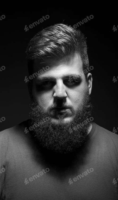 Preview: Bored Mysterious Male Portrait. Low Key, Black Background.