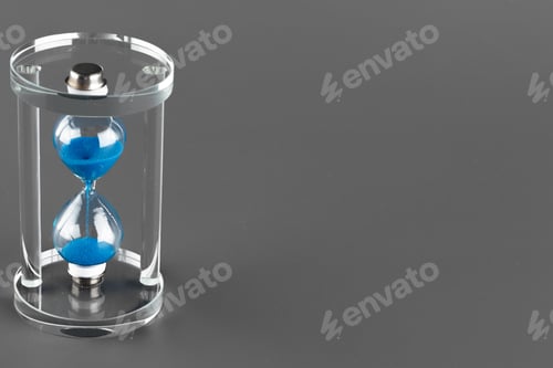 Preview: Blue hourglass on gray background close up