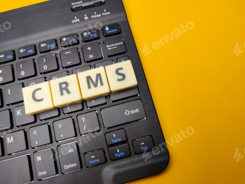 Preview: Black keyboard and toys word with the word CRMS on yellow background.