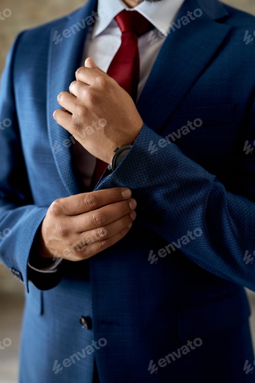 Preview: Unrecognizable businessman adjusting cuff sleeve.