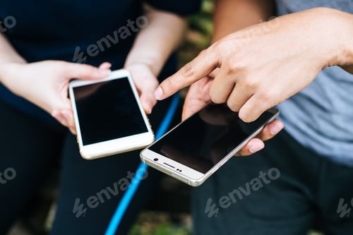 Preview: Close up of friends hands play with smartphone together.