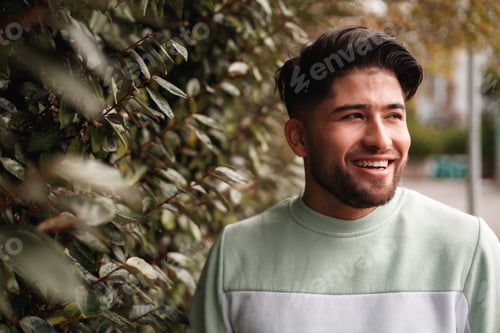 Preview: portrait of young colombian man in sportswear in nature