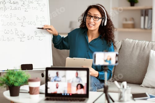 Preview: Young teacher showing board, giving virtual lecture to diverse students