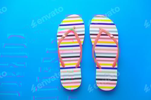Preview: Colorful Striped Flip-Flops on a Blue Background