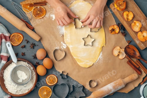 Preview: female hands making cookies from fresh dough at home