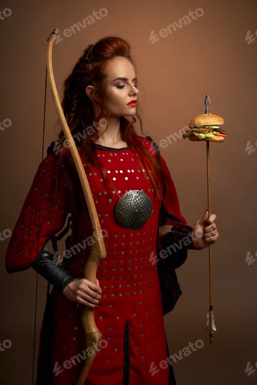 Preview: Female warrior holding arrow with hamburger, posing