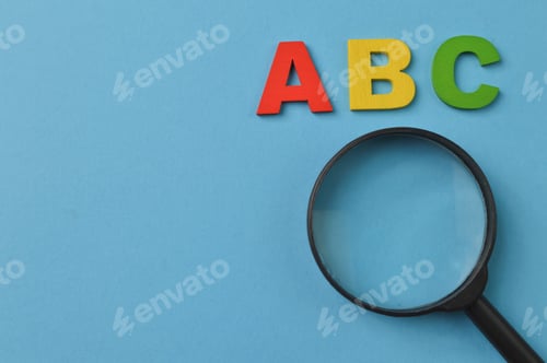 Preview: Magnifying glass and ABC letters isolated on a blue background with copy space