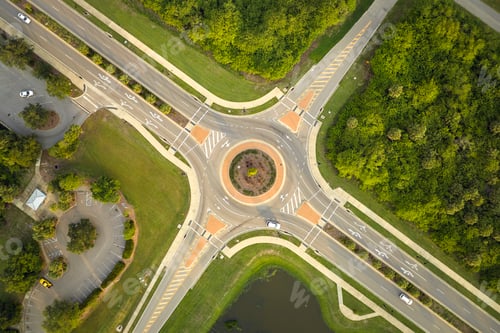 Preview: Aerial view of road roundabout intersection with moving cars traffic.
