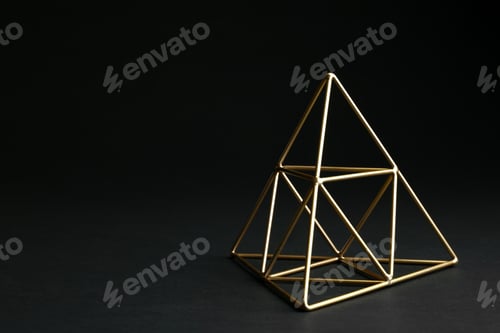 Preview: Shiny decorative gold pyramid on black background. Space for text