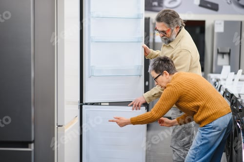Preview: Senior couple choosing new refrigerator in appliance store