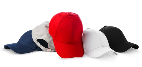 Preview: Colorful Assortment of Baseball Caps and a Ball on White Background
