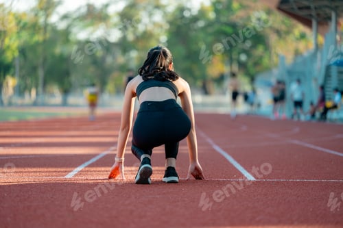 Preview: Female athlete preparing for race on running track