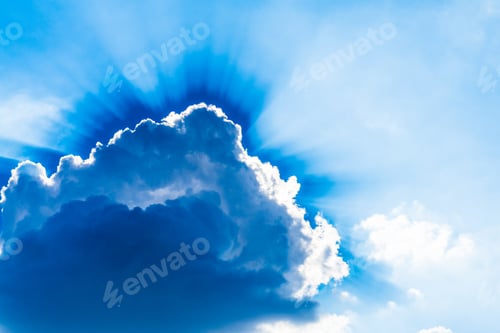Preview: Sunburst behind cumulus cloud, rays of sun from heaven. Beautiful beam of light