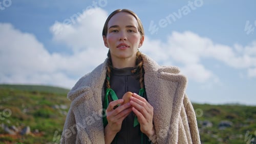 Preview: Woman holding fresh egg on green field. Healthy eating sustainable lifestyle
