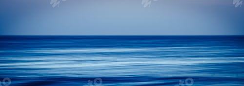 Preview: artistic image with blurry and stretched ocean blue water in long exposure with movement