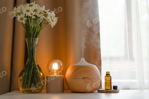 Preview: Aromatherapy concept. Aroma oil diffuser on the table against the window.