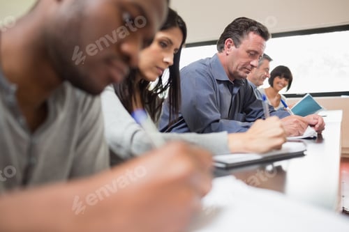 Preview: Students In A Lecture With One Woman Looking Up In College