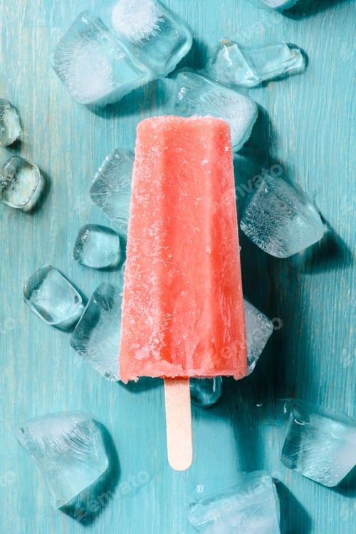 Preview: Red fruit ice pop on wooden background with ice cubes